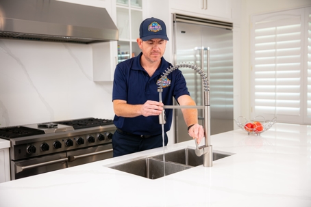 Tech checking work on kitchen faucet