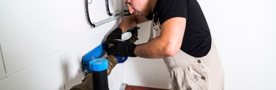 Plumber working on pipes