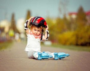 Baby trying to put on a helmet