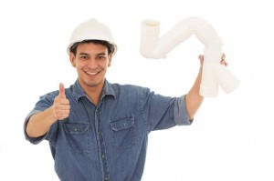 man holding a piece of pipe and giving a thumbs up