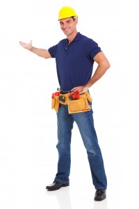Male plumber wearing a hard hat and tool belt 