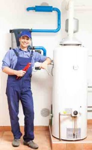 Plumber standing next to a water heater