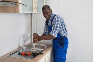 Plumber working in a sink