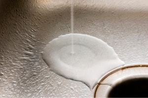 water going down the drain in a sink