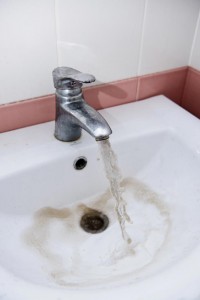 Faucet turned on with dirty running water coming out