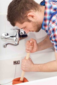 Man plunging a bathtub