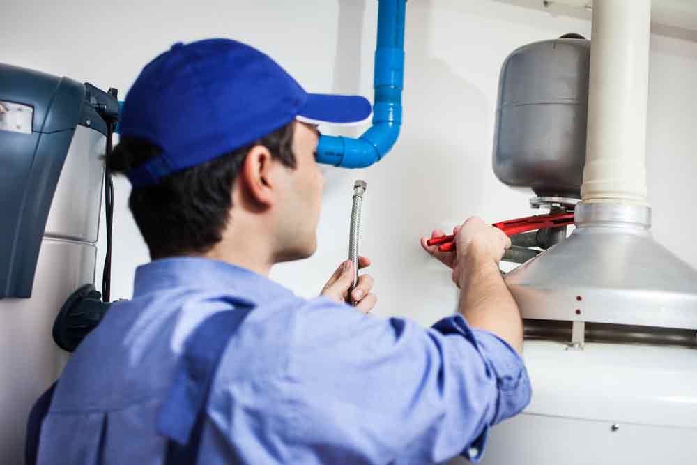 Plumber working on a water heater