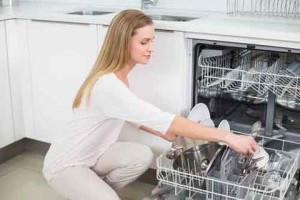 Woman loading dishes into the dishwasher