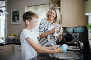 Mom and son washing dishes