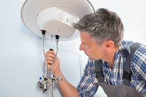 Plumber working on a water heater